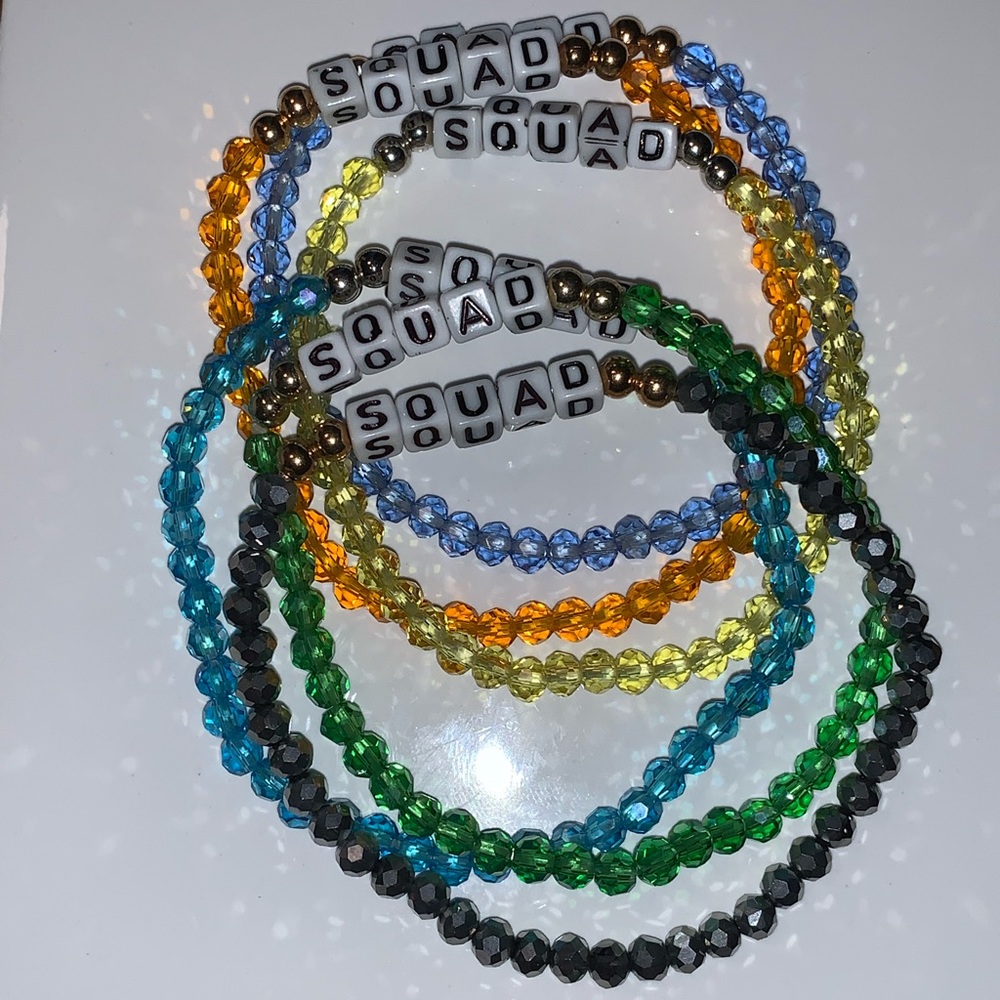 6 stretchy bracelets that read “Squad”.